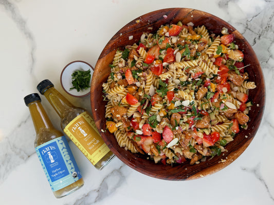 Spring Chicken and Strawberry Pasta Salad made with pasta, chicken, strawberries, mango, basil, and Nan’s vinaigrettes.