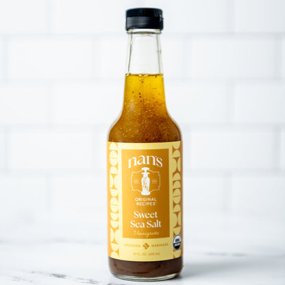 Bottle of Nan's Sweet Sea Salt on a marble surface with a white background